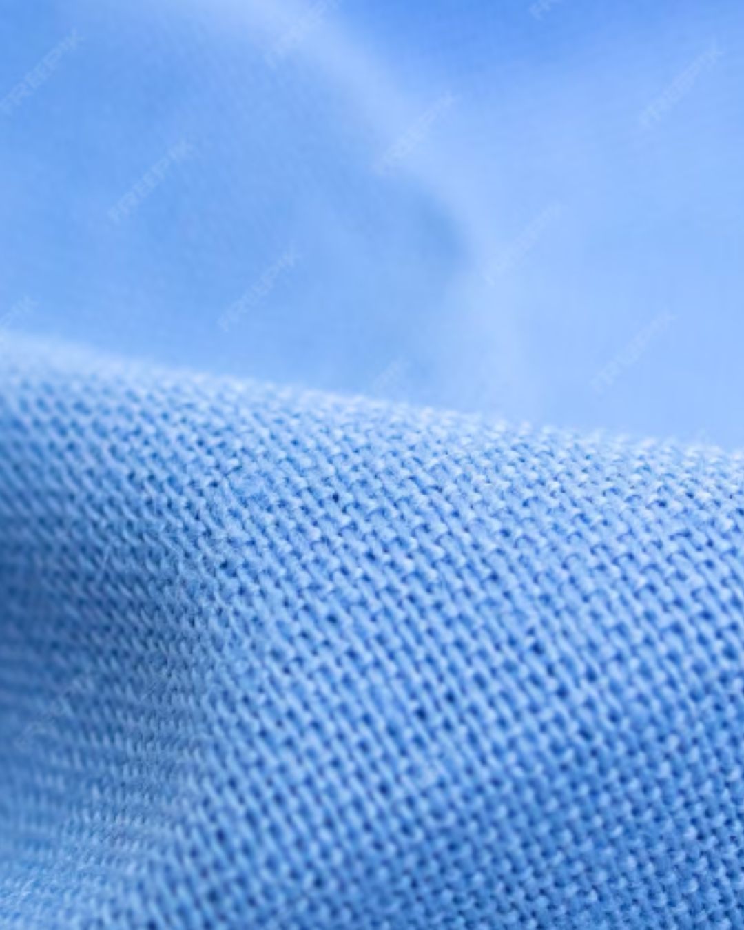 Close-up view of blue cotton knit fabric texture highlighting soft breathable weave and smooth surface